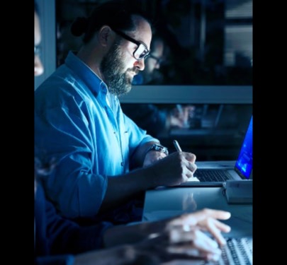 Engineers collaborating on security architecture tools in an office